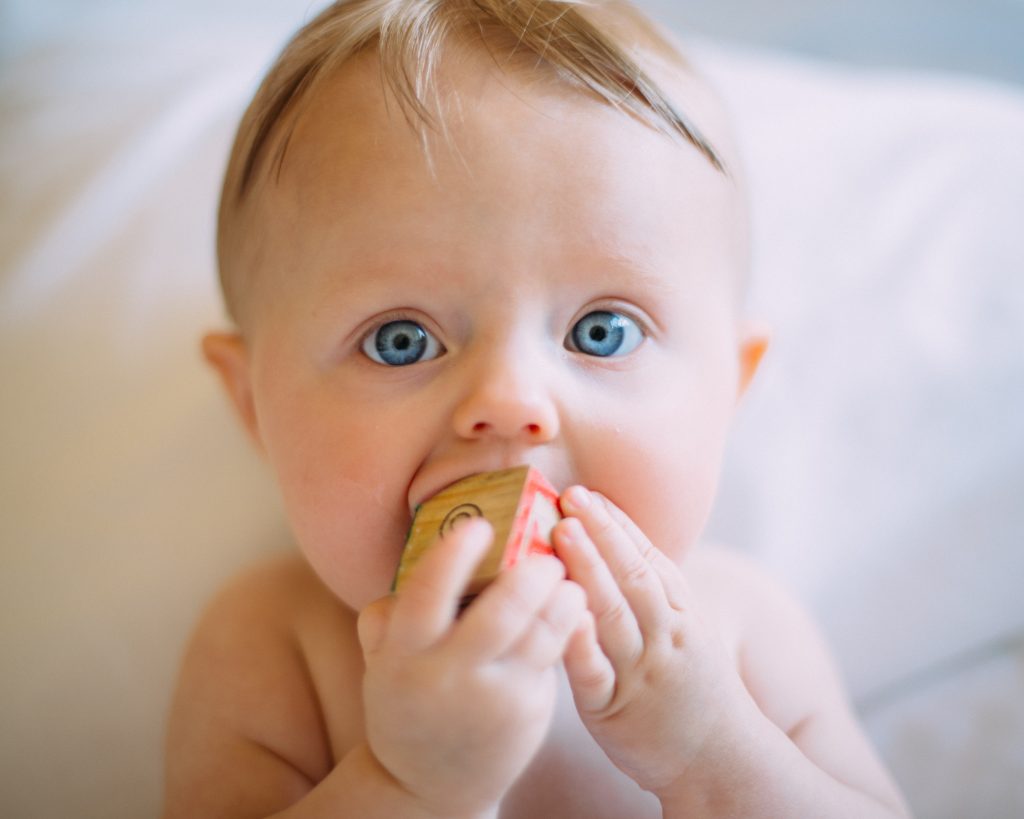 infants play with wooden blocks 