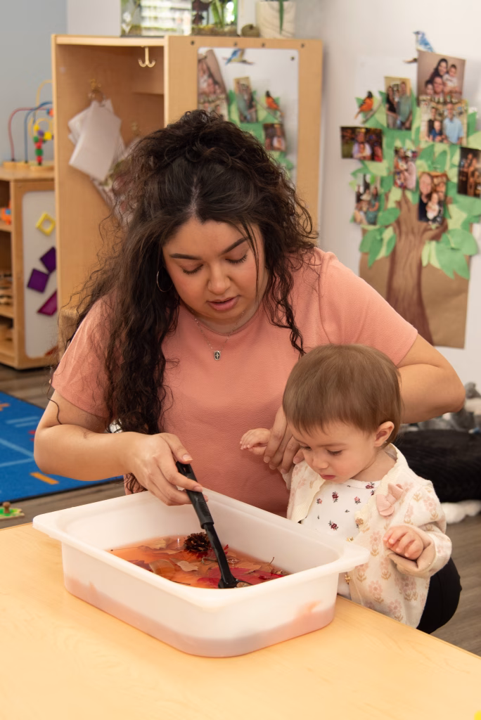 Montessori guide observing toddler at work in classroom