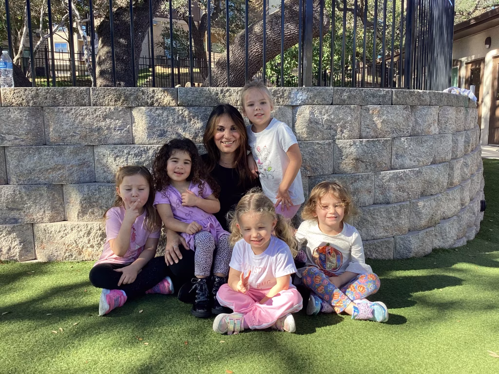 edquisitive montessori of fair oaks boerne teacher with children in outdoor learning environment