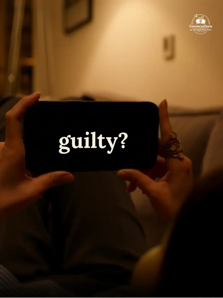 A parent holding a phone in a dimly lit room with the word "guilty?" on the screen — Conversations for the Beginning Years with Melissa Zamora